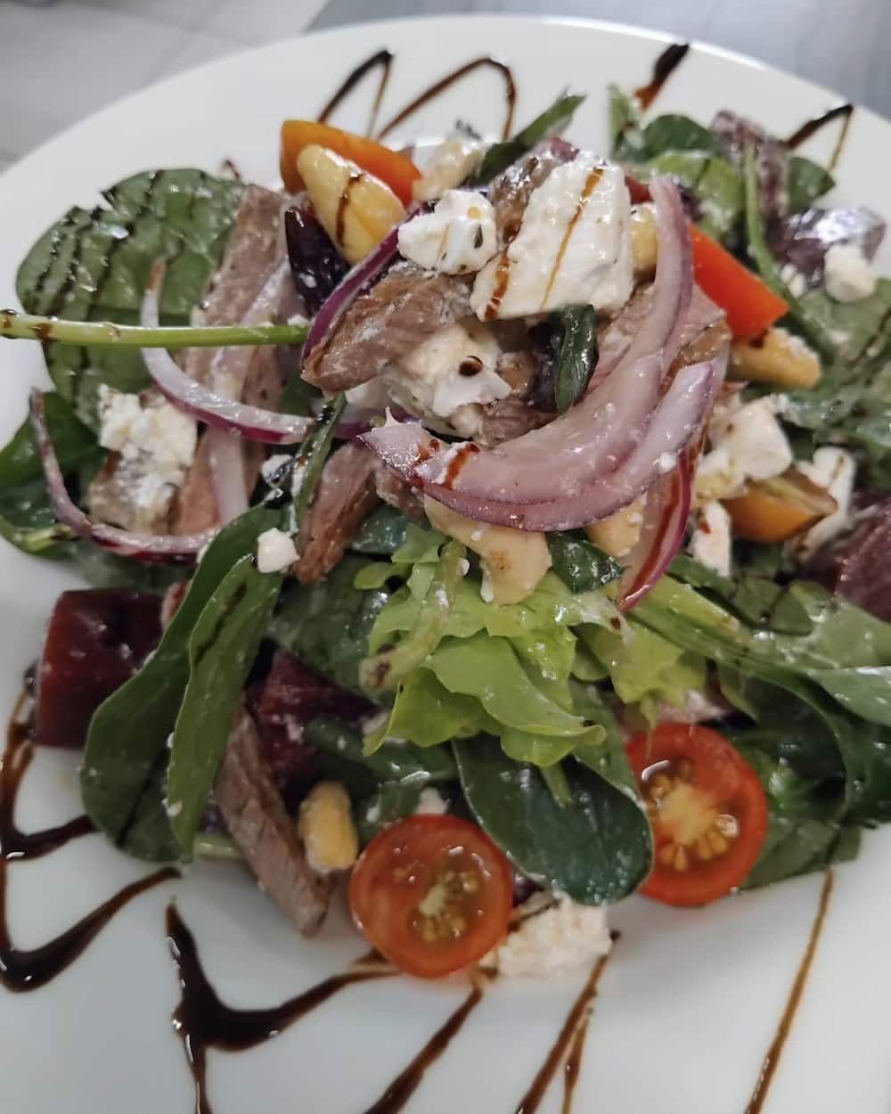 A Close Up Of A Salad On A White Plate — Vines at 139 in Grafton, NSW