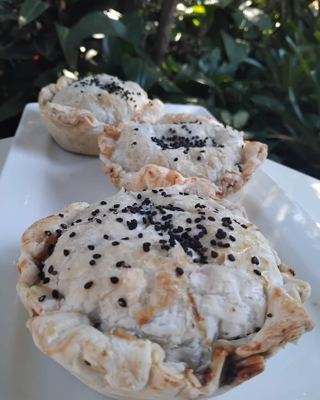 Three Pies With Black Sesame Seeds On A White Plate — Vines at 139 in Grafton, NSW