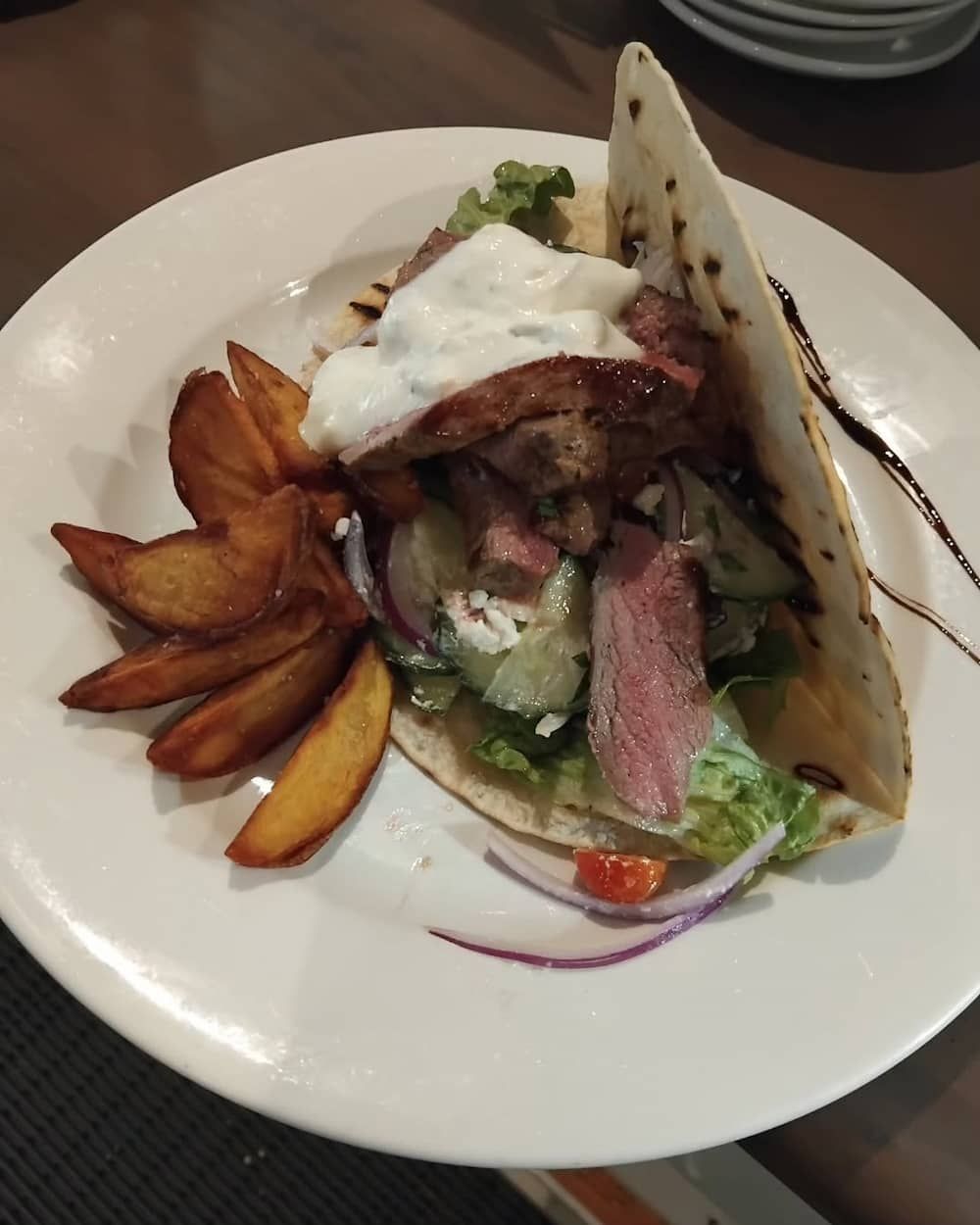 A White Plate Topped With A Taco And French Fries — Vines at 139 in Grafton, NSW