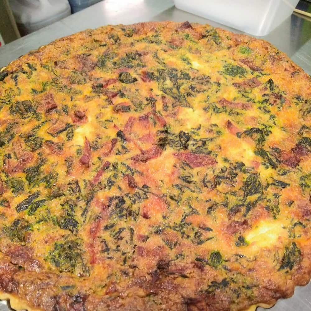 A Large Pizza Is Sitting On Top Of A Metal Table — Vines at 139 in Grafton, NSW