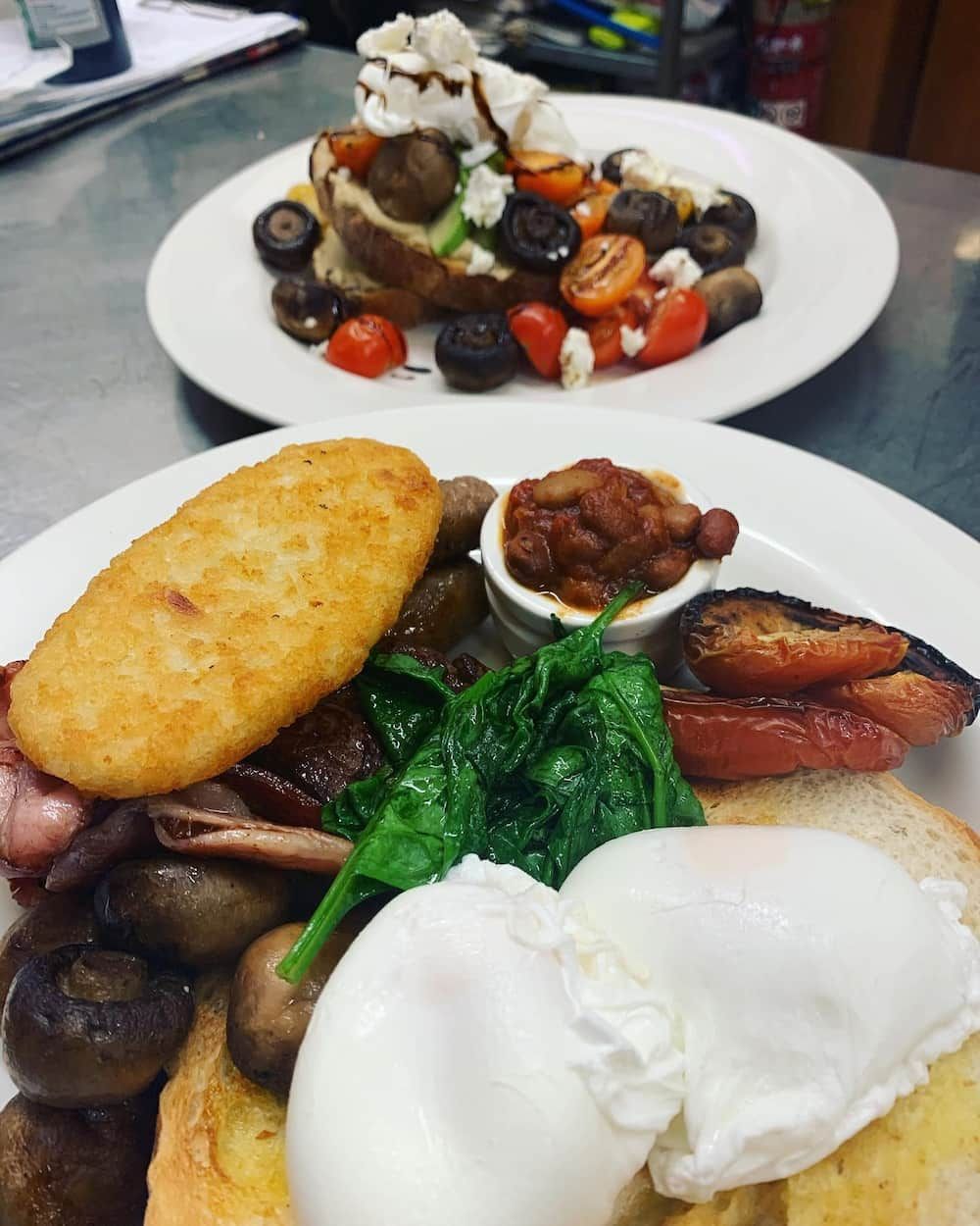Two Plates Of Food On A Table Including Eggs And Beans — Vines at 139 in Grafton, NSW
