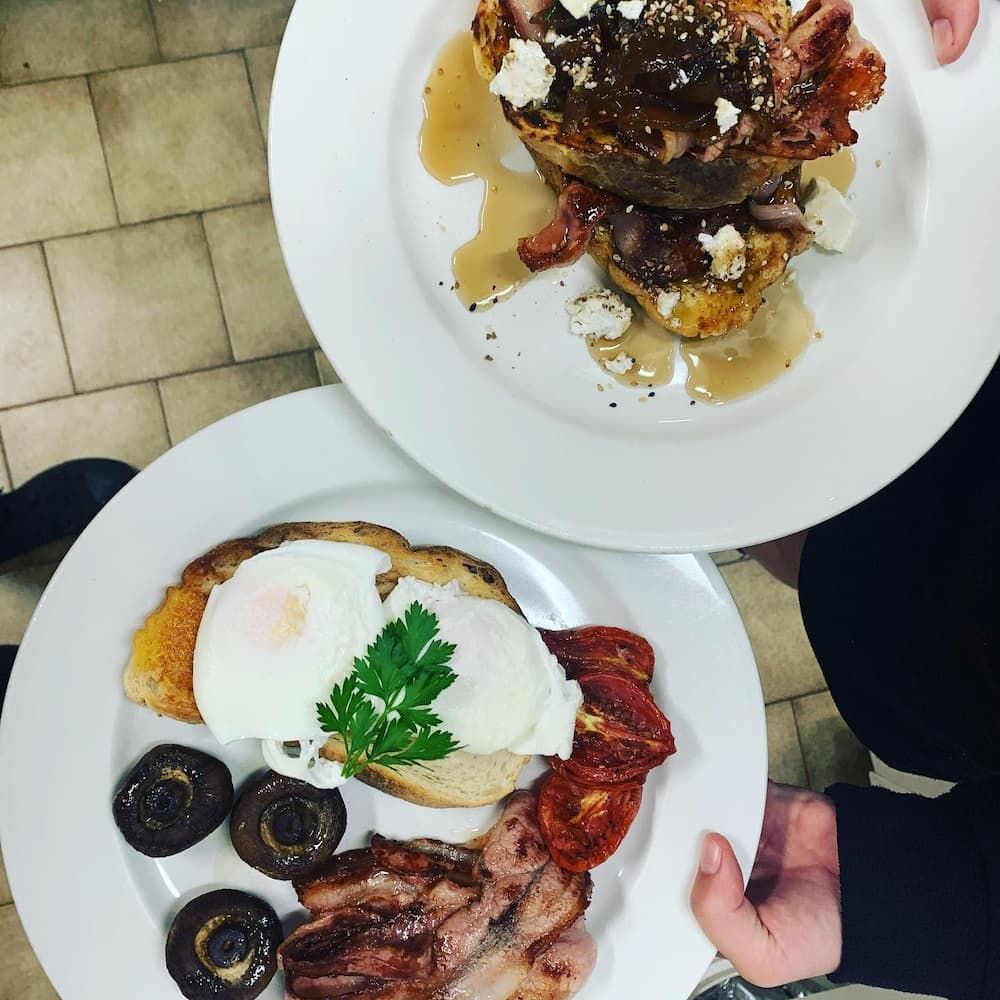 Two Plates Of Food With Eggs Bacon And Mushrooms On Them — Vines at 139 in Grafton, NSW