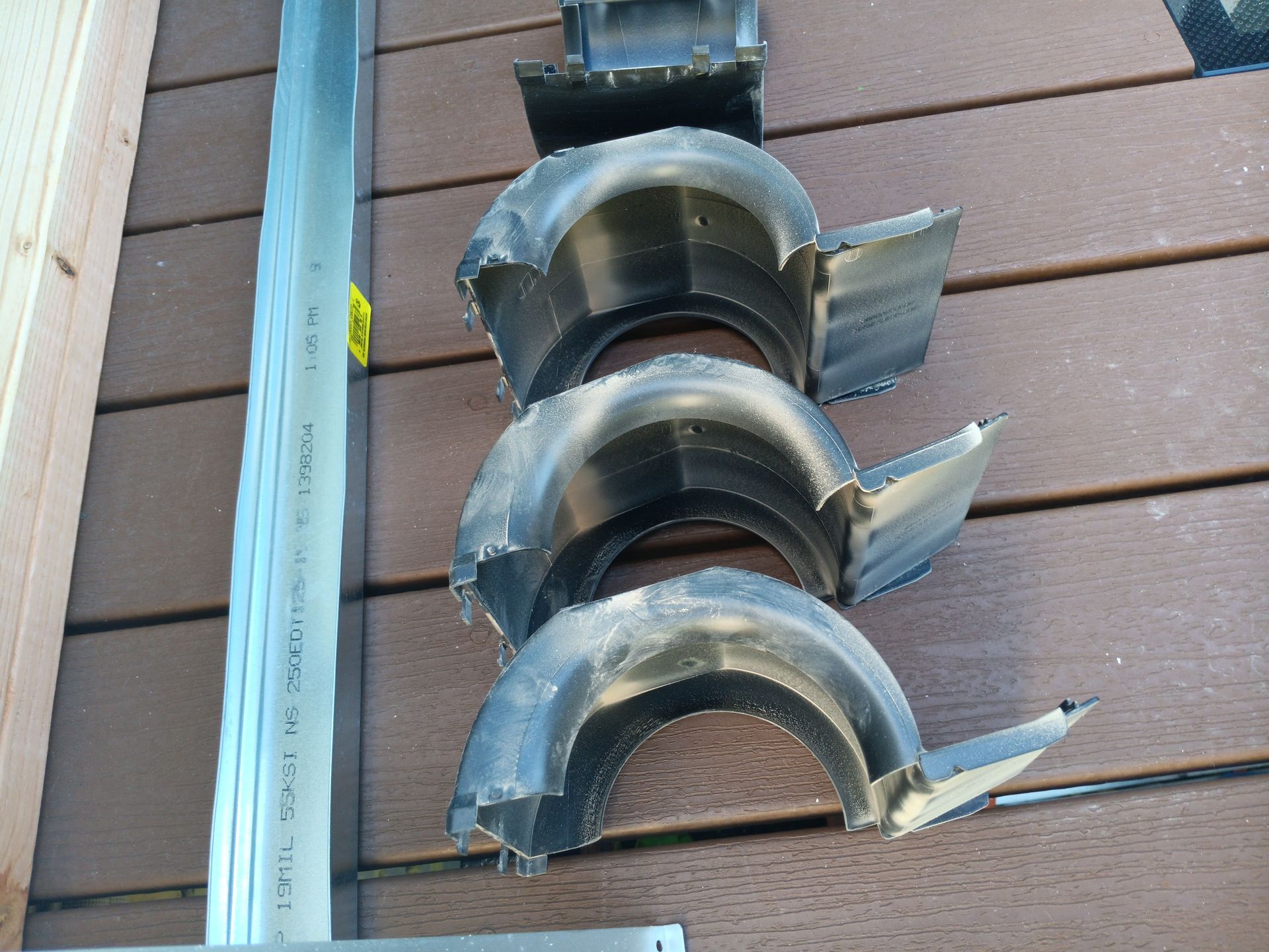 A bunch of pieces of metal are sitting on a wooden table