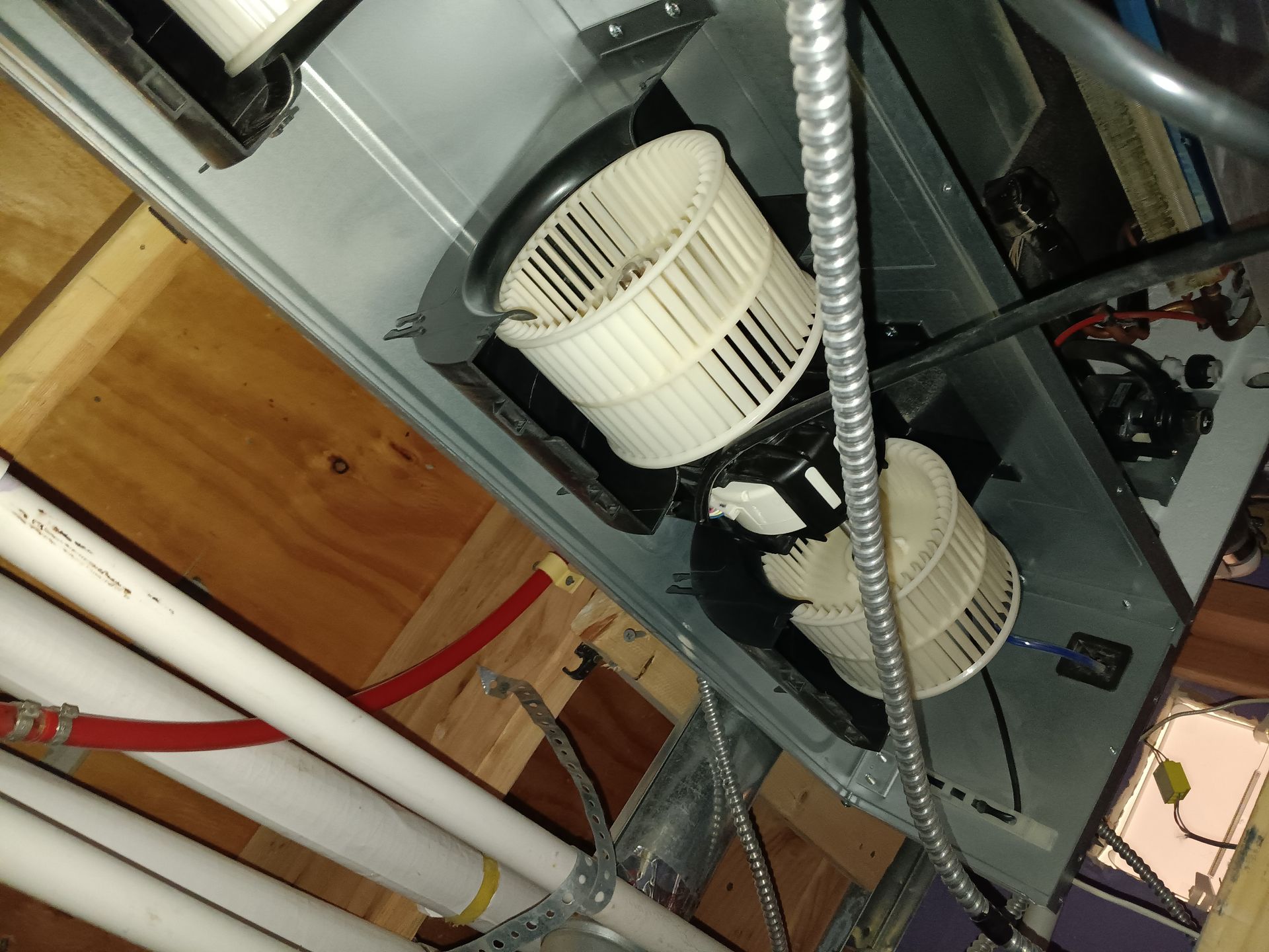 A fan is hanging from the ceiling of a room.