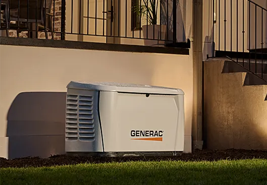 A generator is sitting on the side of a building next to an air conditioner.