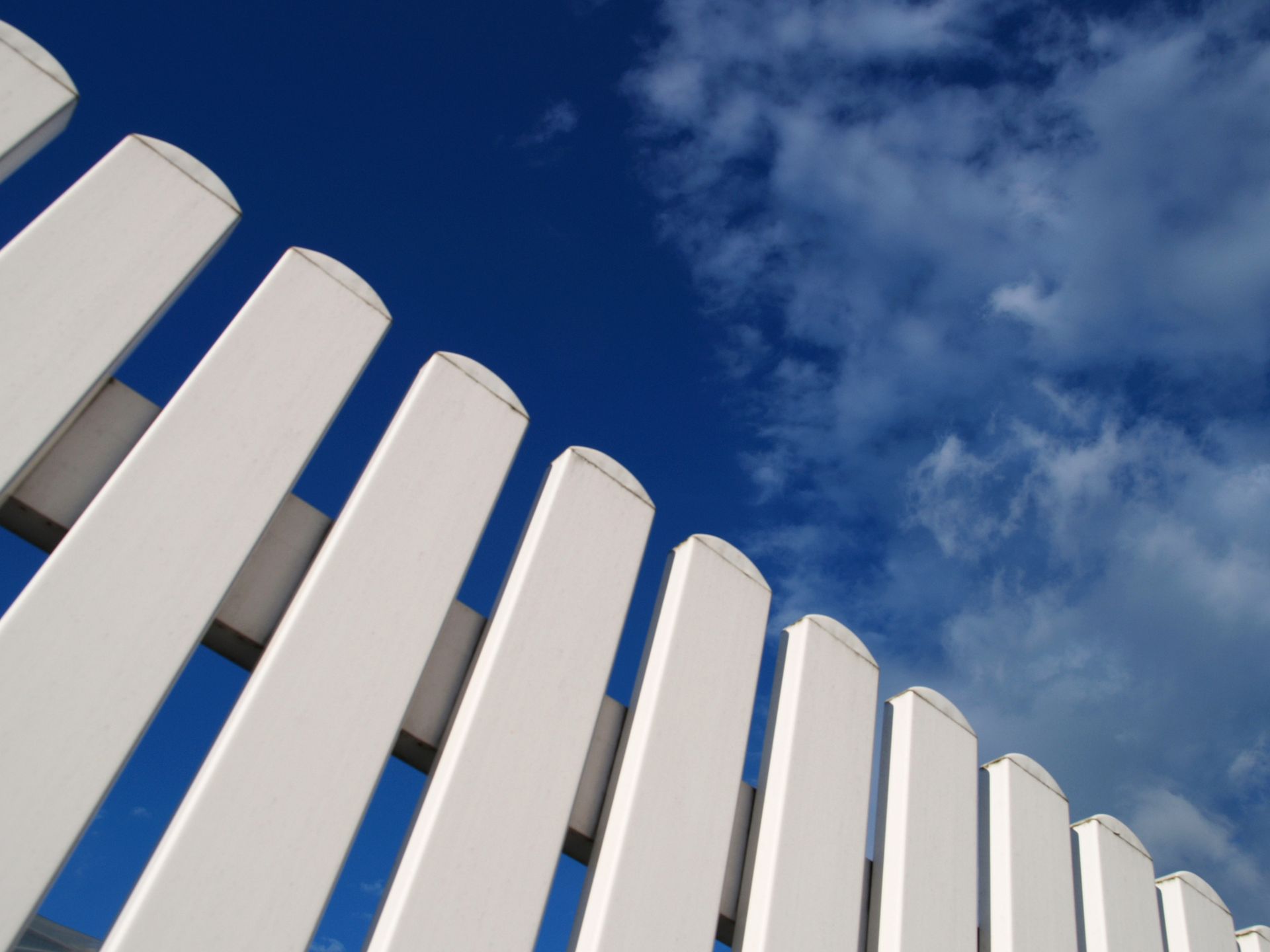 White fence pickets showcasing quality work by a professional fence installation contractor.