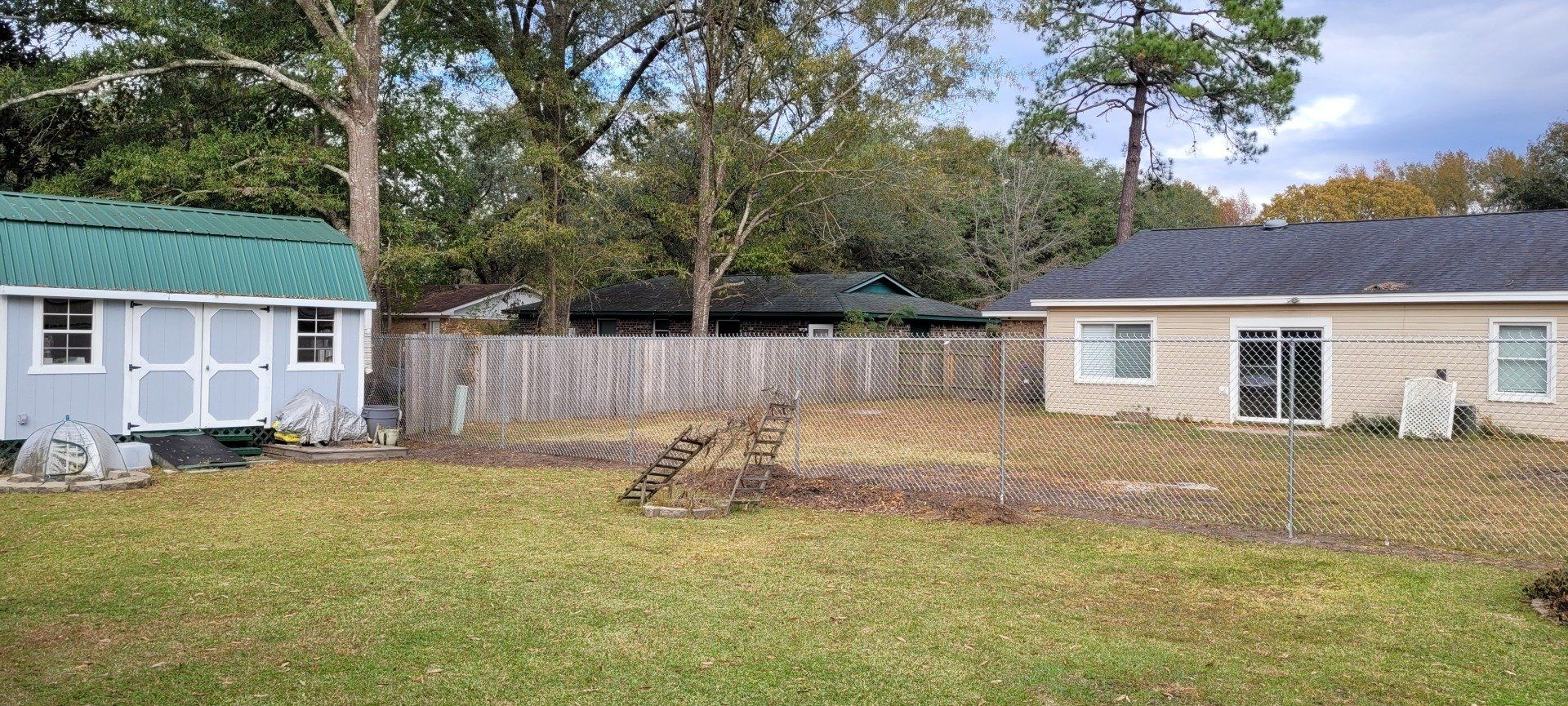 A couple of houses are sitting next to each other in a grassy yard.