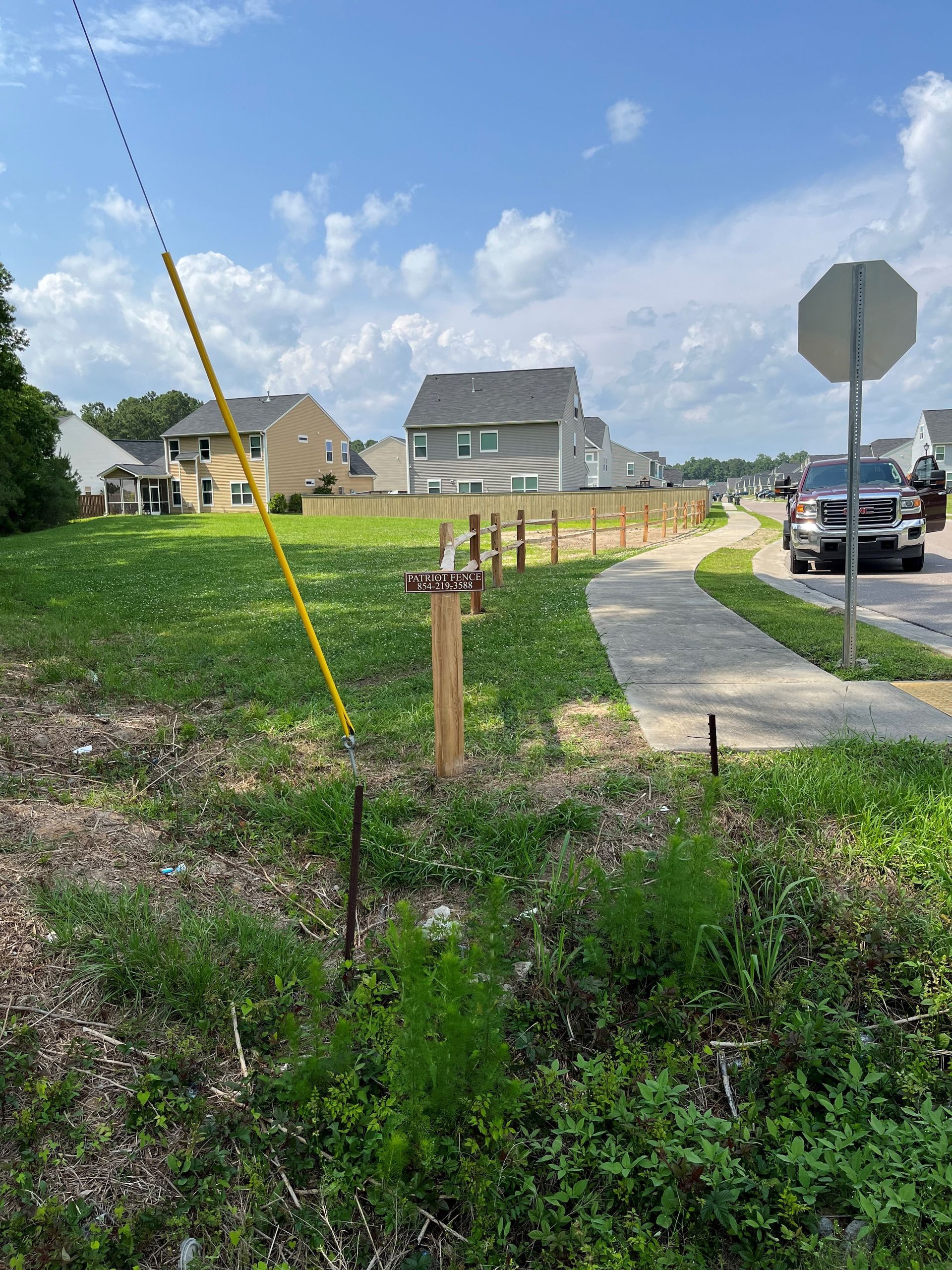 There is a stop sign in the middle of a grassy field.