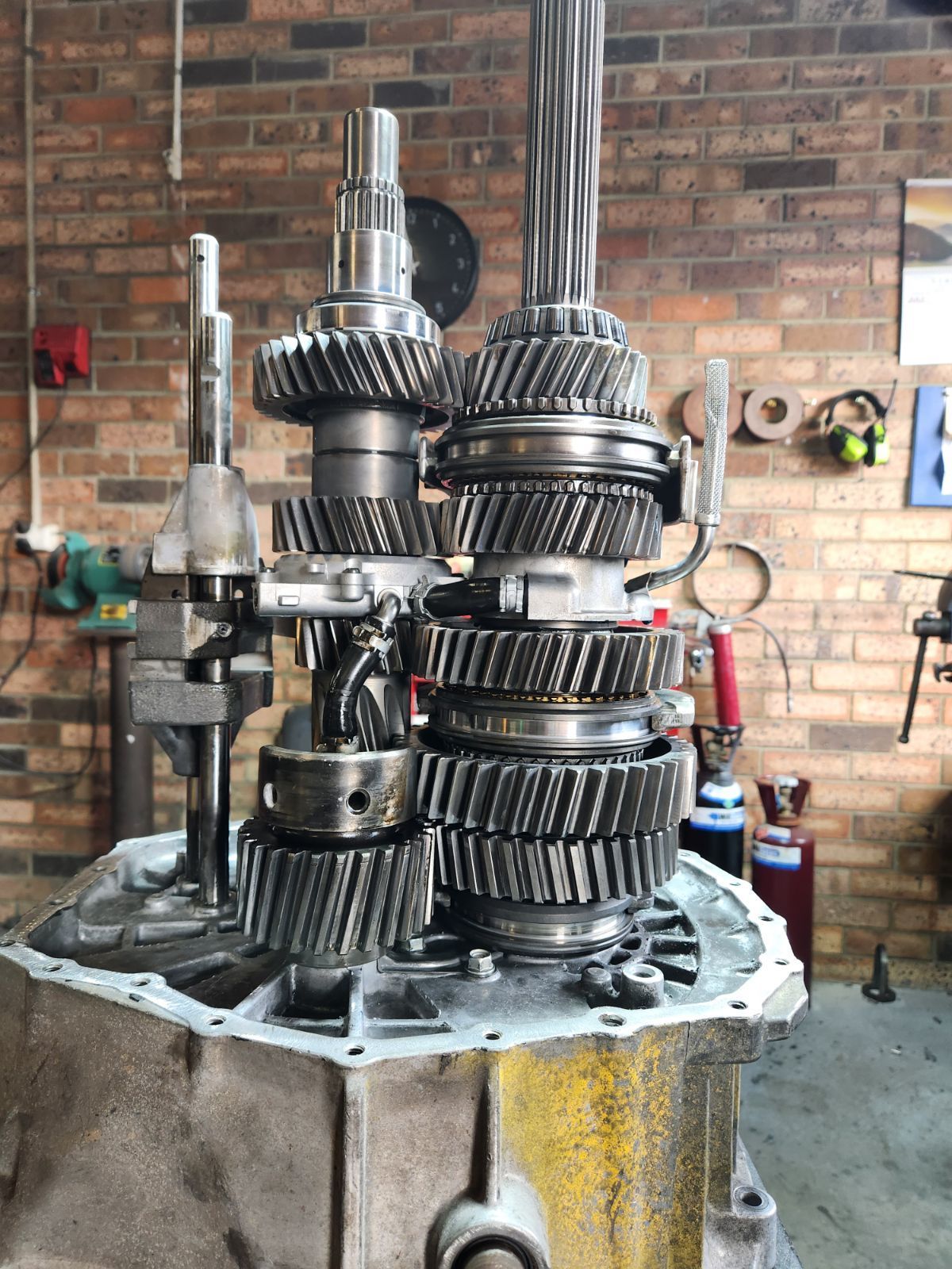 A bunch of gears are stacked on top of each other in a garage.