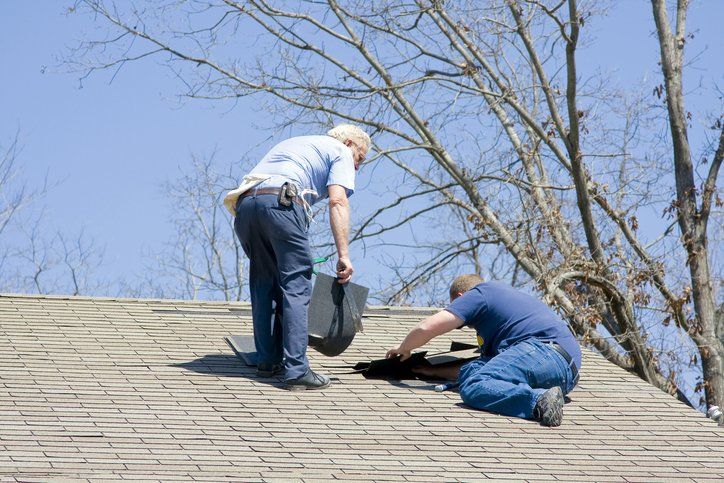Contractors repairing roof