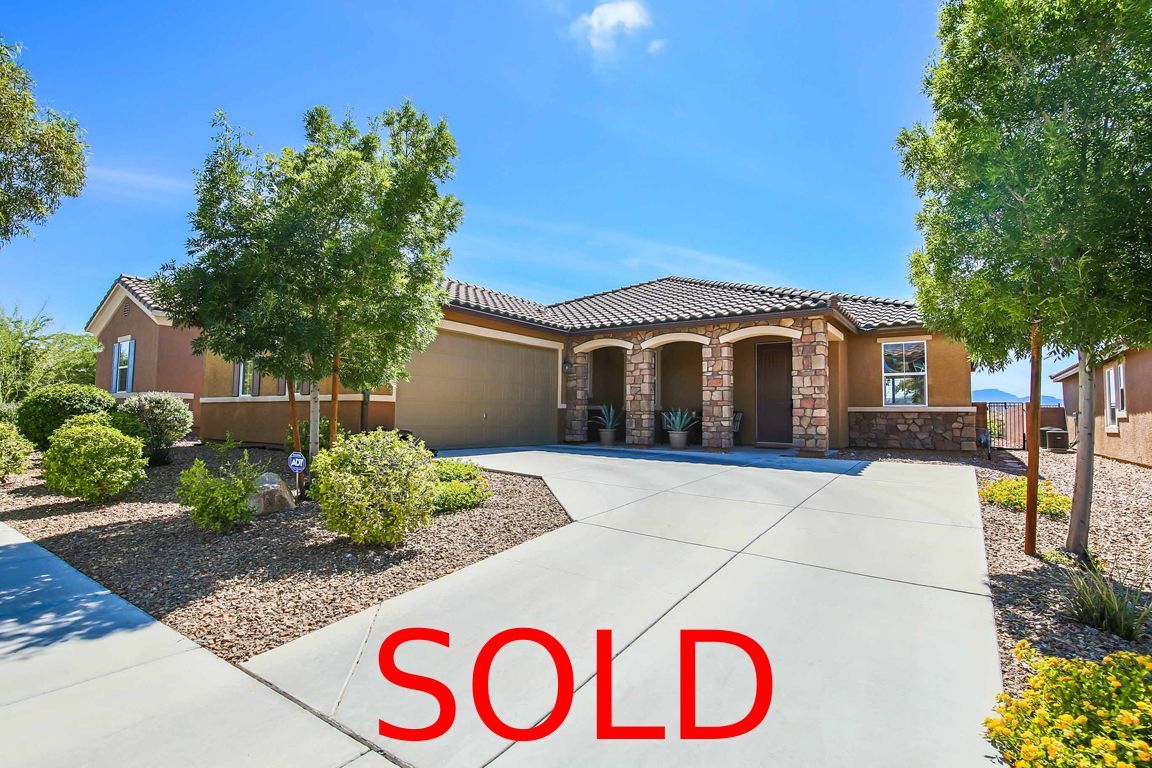 A dining room with a table and chairs and a wooden staircase.