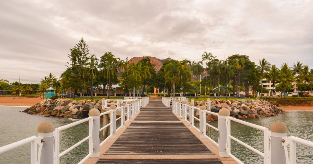A Wooden Dock Leading to A Small Island in The Middle of The Ocean — Laneway Adult Shop in Townsville,, QLD