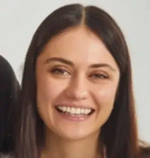 Smiling woman with dark hair, light skin, and brown eyes.