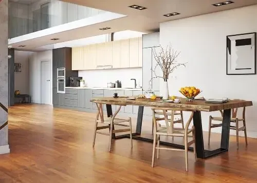 Bright, open living room with a brick fireplace, water views, and wood accents.