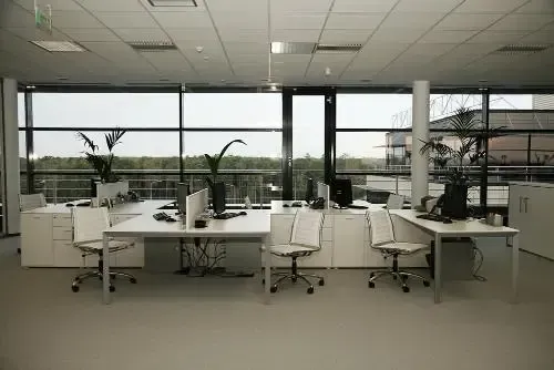 Bright, open living room with a brick fireplace, water views, and wood accents.