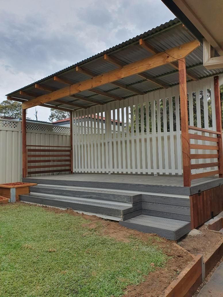 A Wooden Porch With a Roof and Stairs in a Backyard — Offcut Carpentry In Murwillumbah, NSW