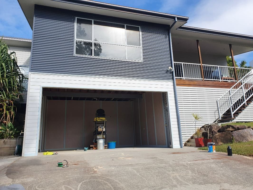 A Large House With a Garage and Stairs in Front of It — Offcut Carpentry In Murwillumbah, NSW
