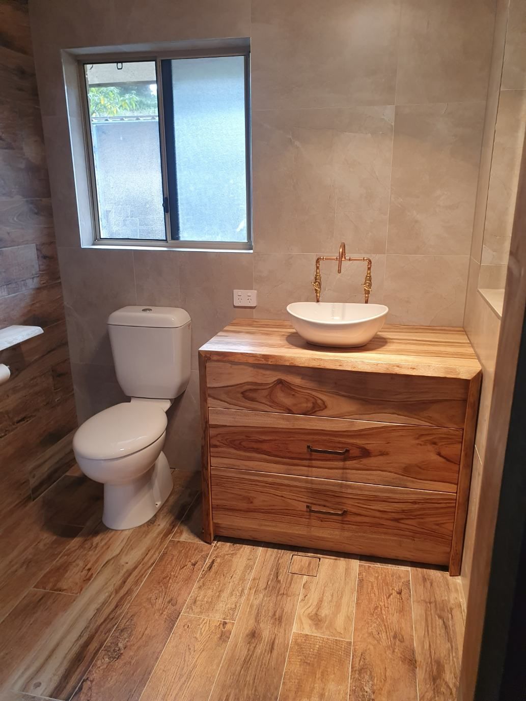 A Bathroom With a Toilet, Sink and Dresser — Offcut Carpentry In Murwillumbah, NSW