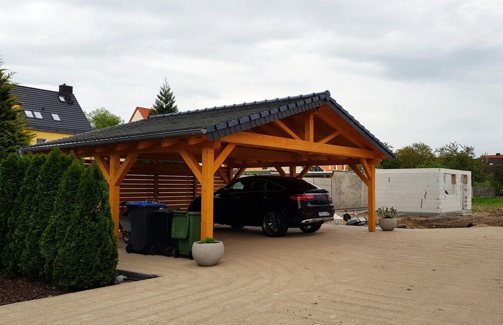 A Car is Parked Under a Wooden Carport in a Driveway — Offcut Carpentry In Byron Bay, NSW