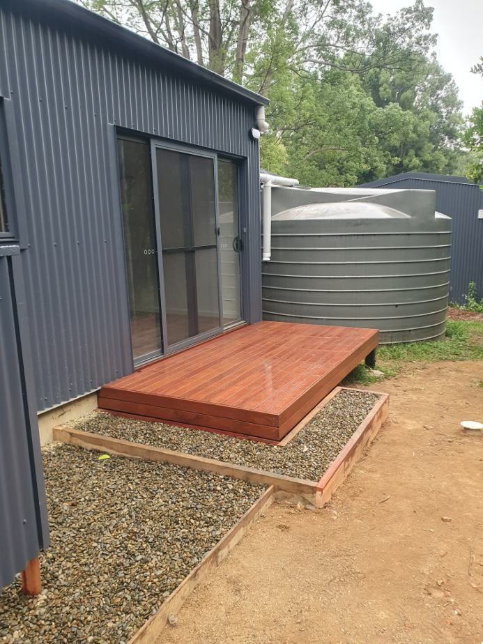 A Small House With a Wooden Deck in Front of It — Offcut Carpentry In Tweed Heads, NSW