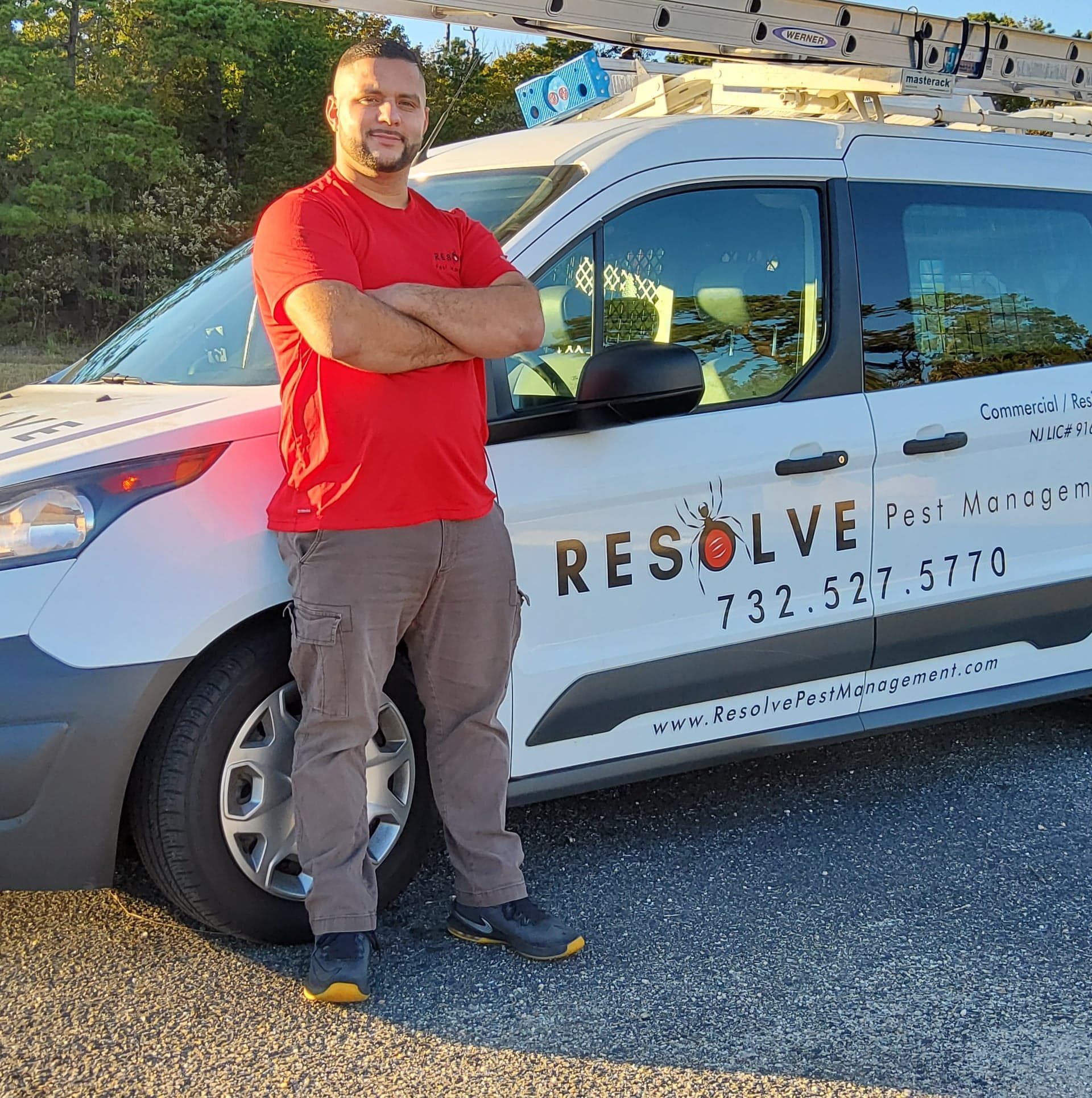 Company owner standing in front of resolve pest management vehicle