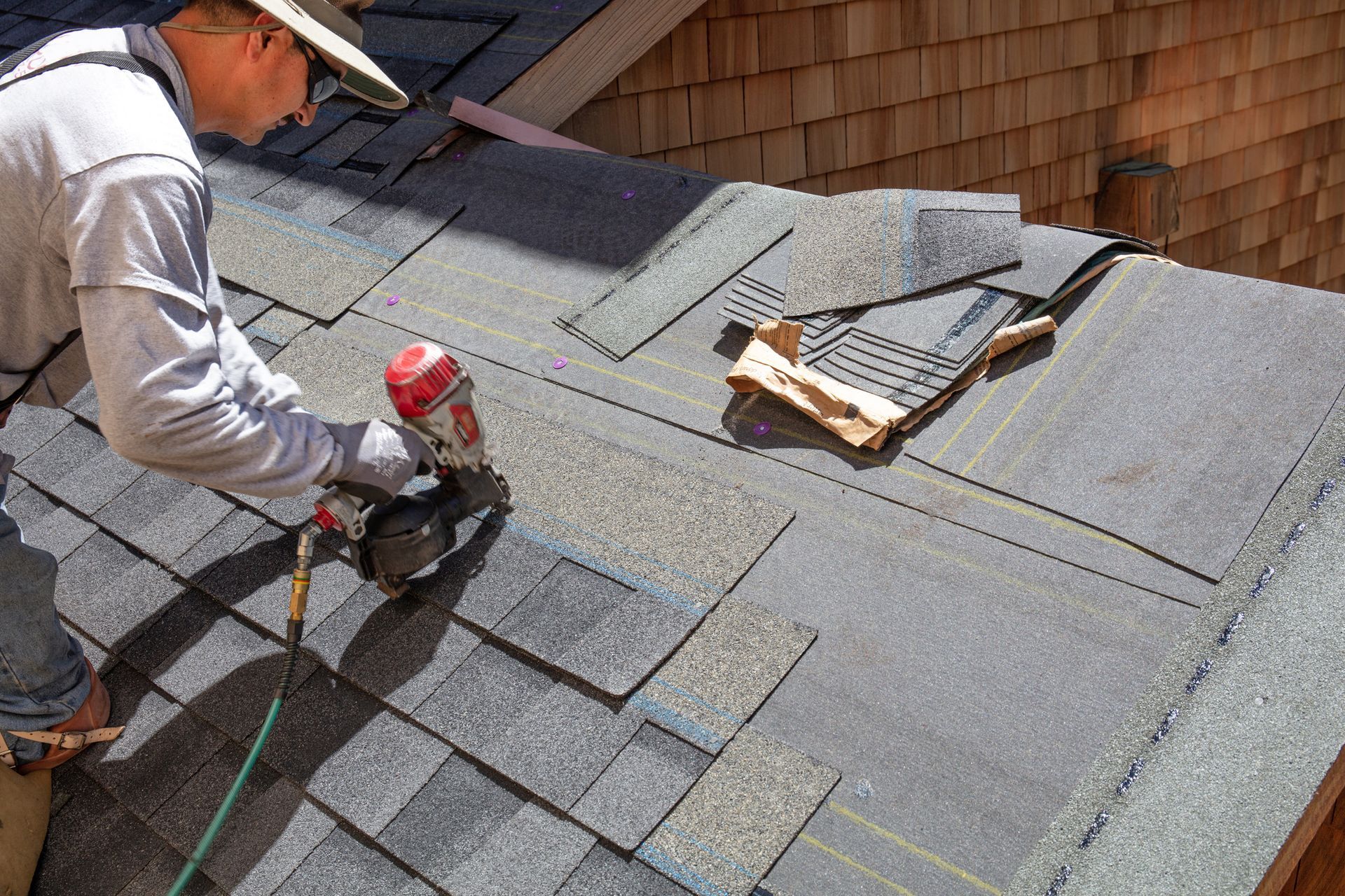 Worker replacing shingle roofing in Ridgewood, NJ