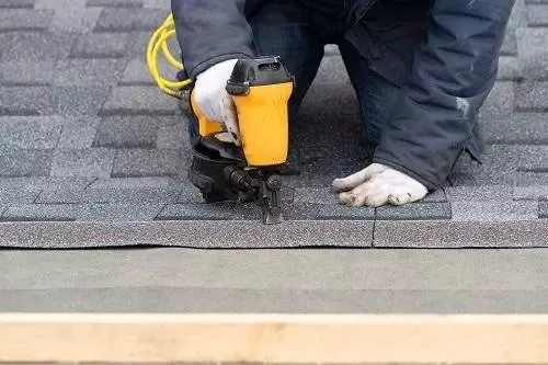 Man Repairing Roof — Hackensack, NJ — Classic Remodeling