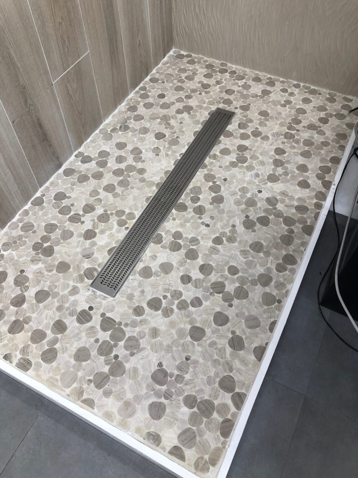 Marble mosaic tiles in heart shapes, ideal for romantic-themed bathroom walls.