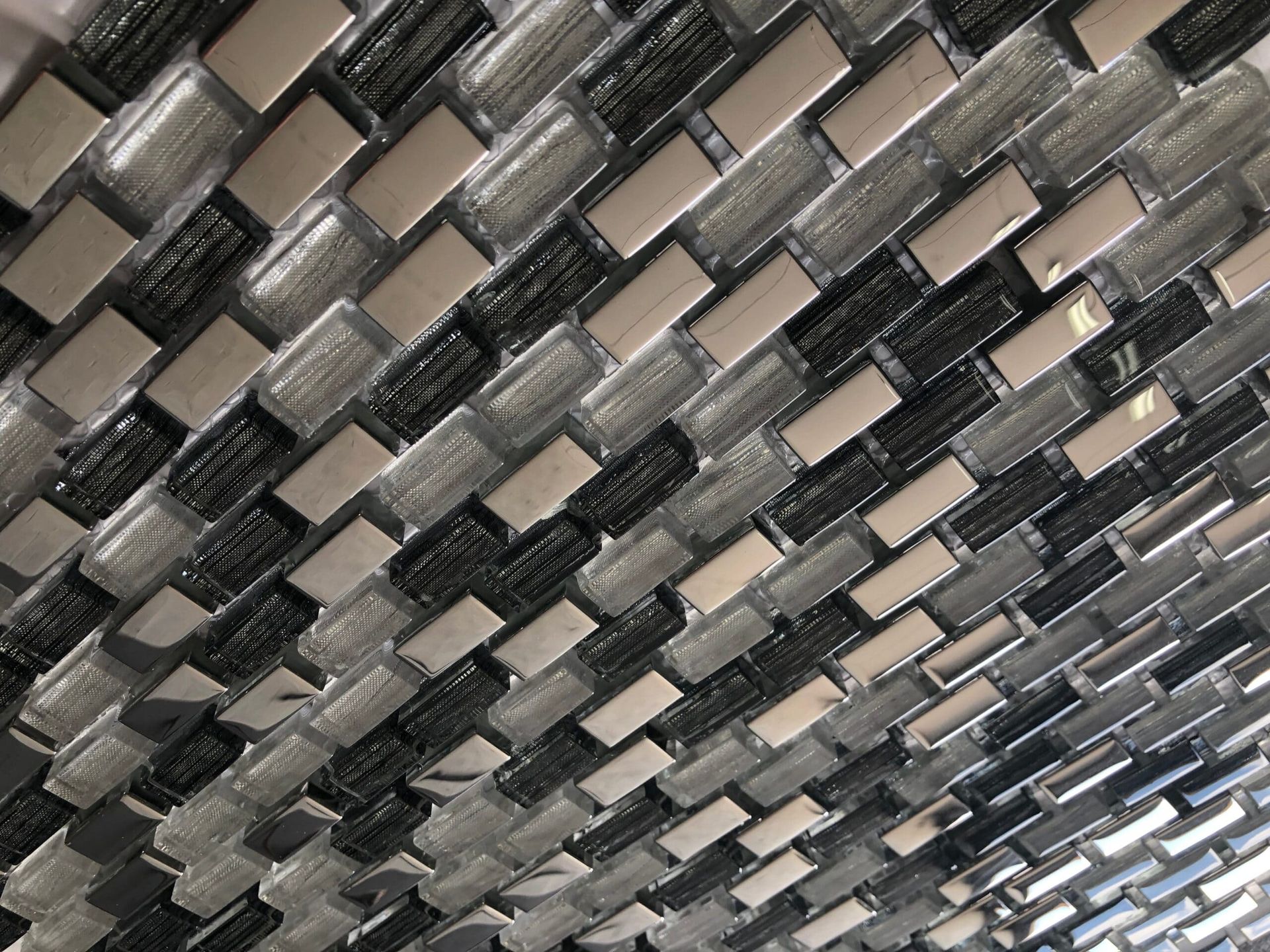 Andria brick-style mosaic tile in earthy tones, suitable for fireplace surrounds and rustic kitchen backsplashes.