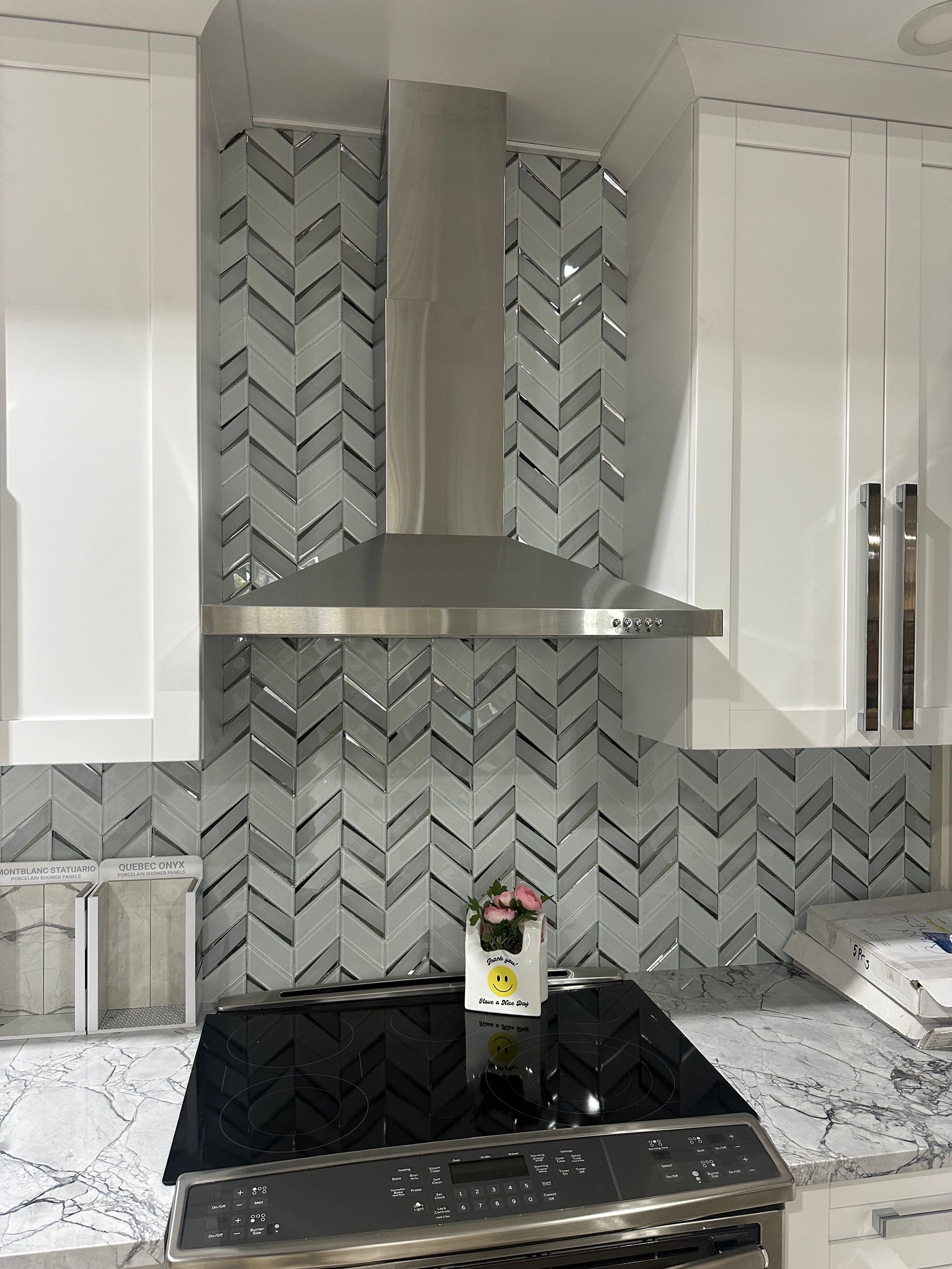 Monaco Chevron mosaic adds a dynamic, elegant pattern to the kitchen backsplash, enhancing the space with timeless style.