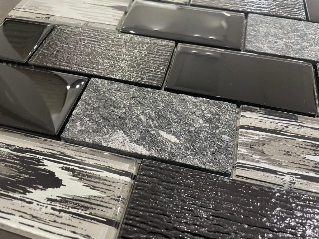 Cheever Place Black Glass mosaic tile combining black and white glass with natural stone chips, perfect for accent walls.