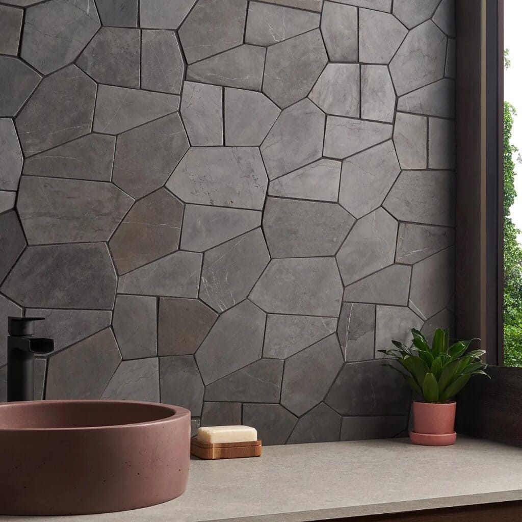 Pentagon-shaped dark grey stone mosaic tile, great for geometric wall or floor designs.
