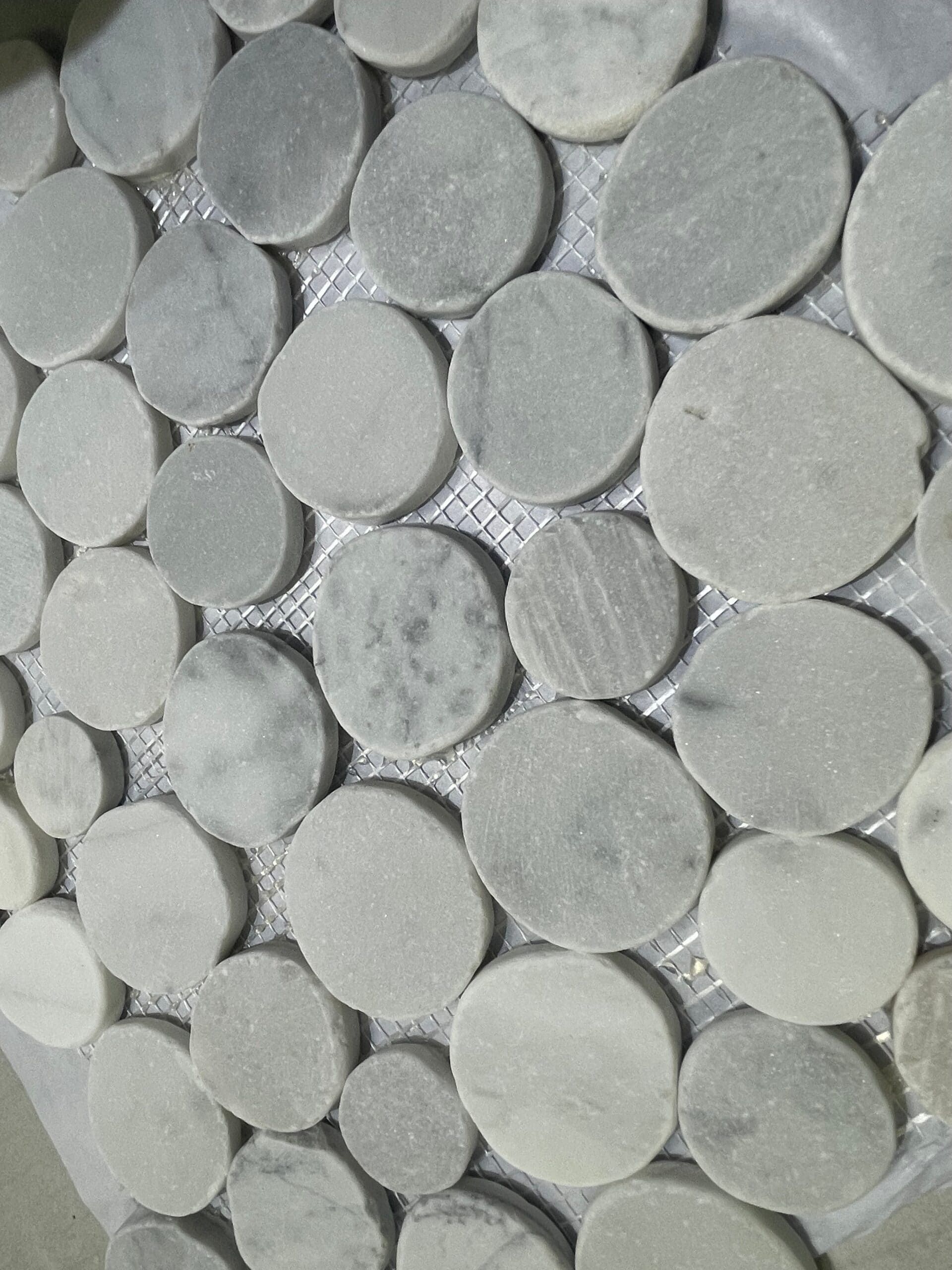 Carrara Moon Stone tile with circular marble pieces, soft and stylish for mosaic feature walls or floors.