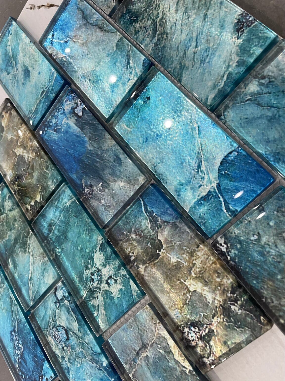 Glossy reef-toned subway glass tiles with ocean hues, ideal for backsplashes and feature walls.