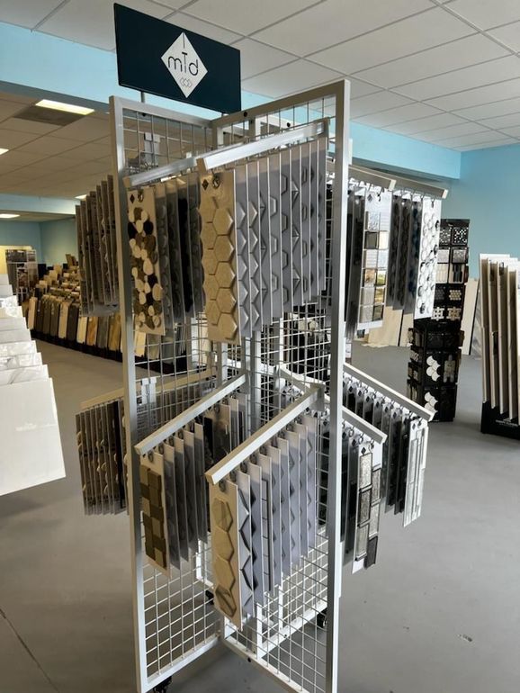 Live popup store display with tile and mosaic depot products on shelves and flooring.