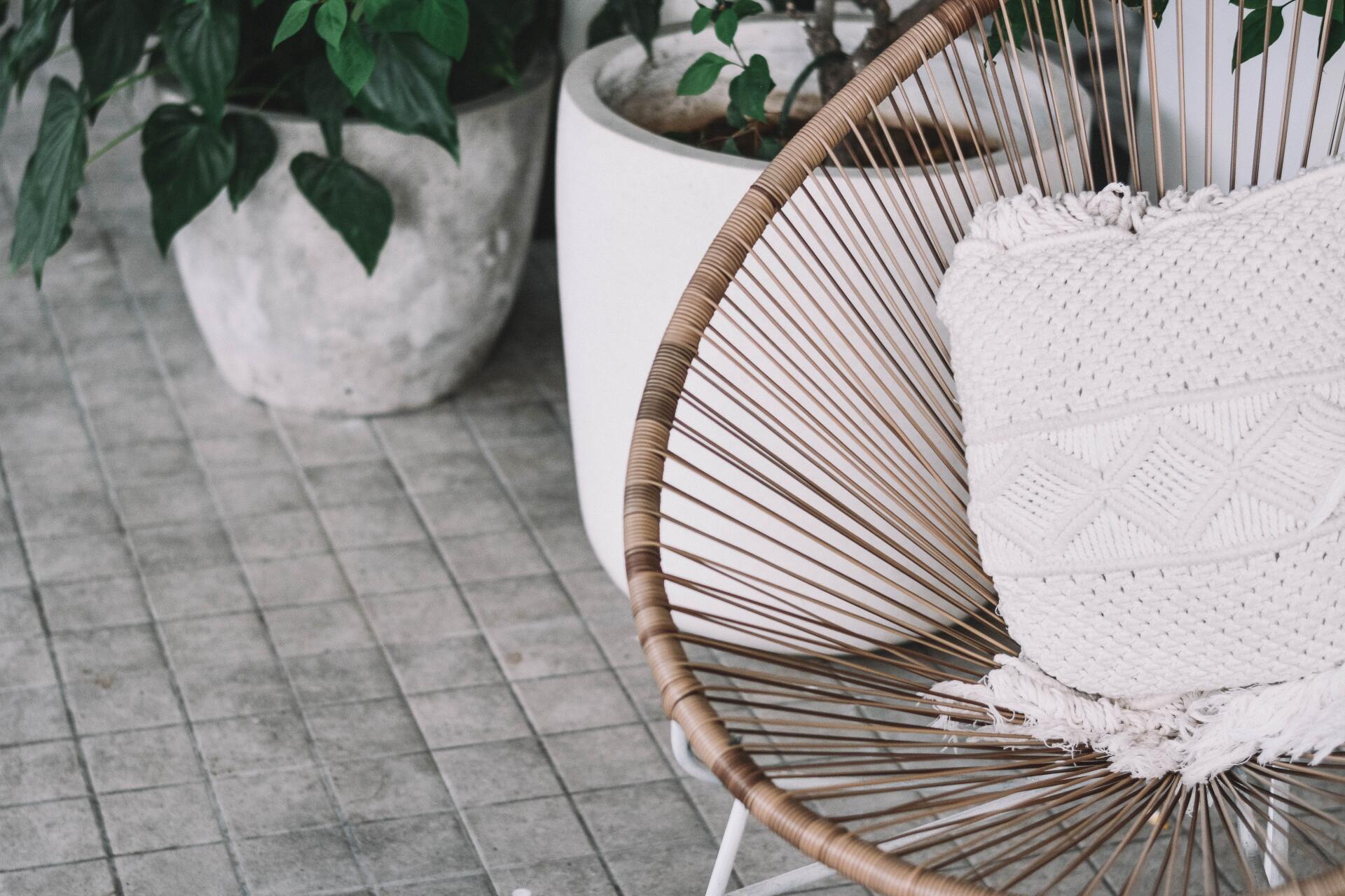 Rattan Chair with Pillow & Plants in White Pots