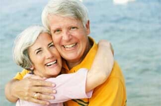 Old couple embracing at beach DiSano Dental Group Wakefield, RI