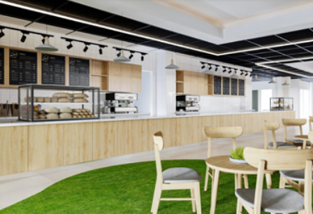 Cafe interior: a counter with coffee machines, wooden chairs, and a grassy area.