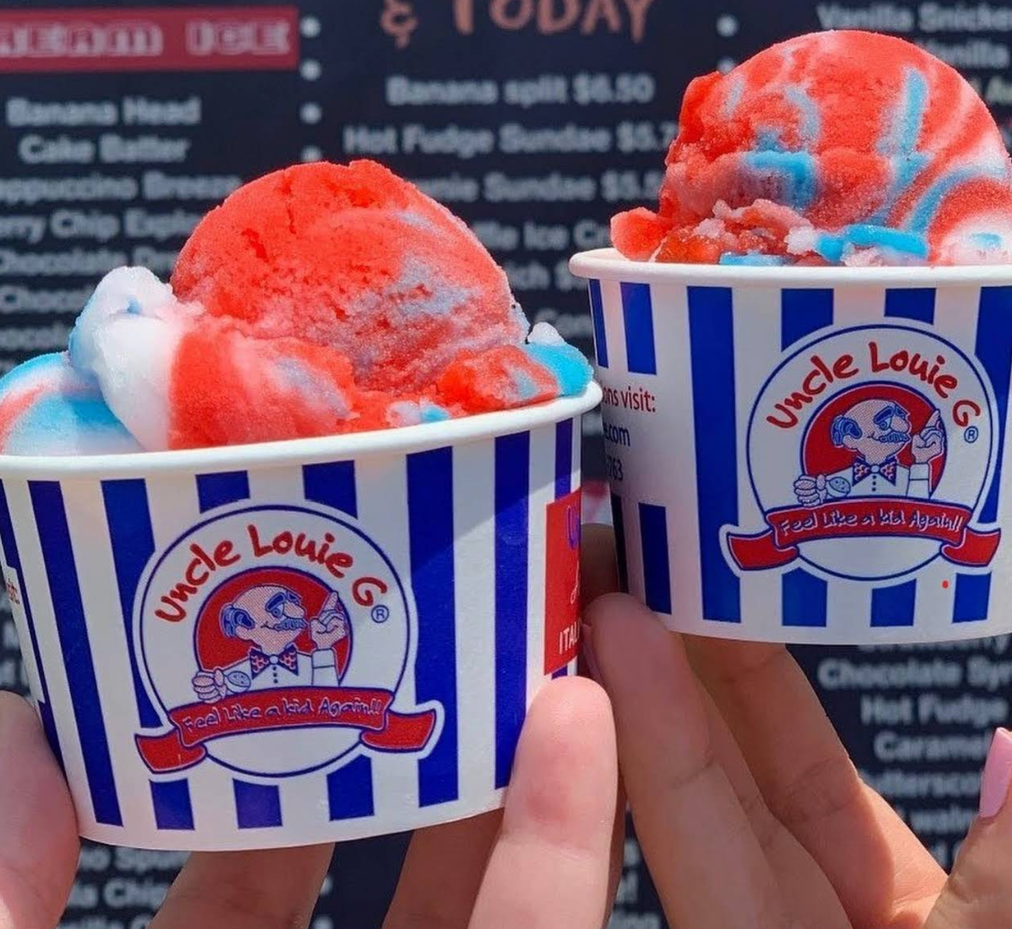 Two cups of red, white, and blue ice cream in striped cups, held by hands, with an