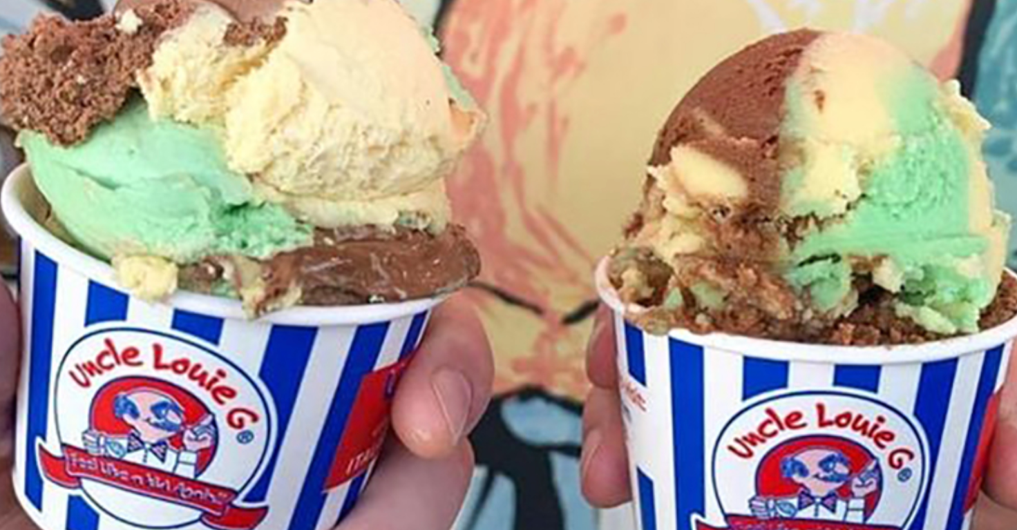 Two ice cream cups with multi-colored scoops. Mint, chocolate, and yellow ice cream in a blue and white striped cup.
