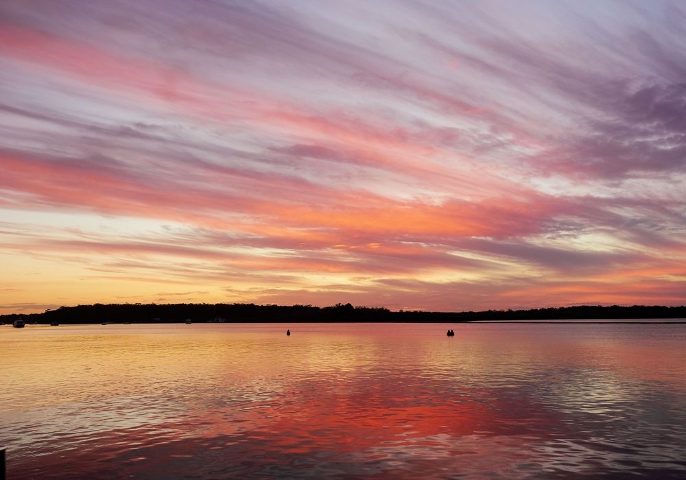 Sunset Over Calm Water Reflects Vibrant Orange — Quality Fences 4 U in Tin Can Bay, QLD