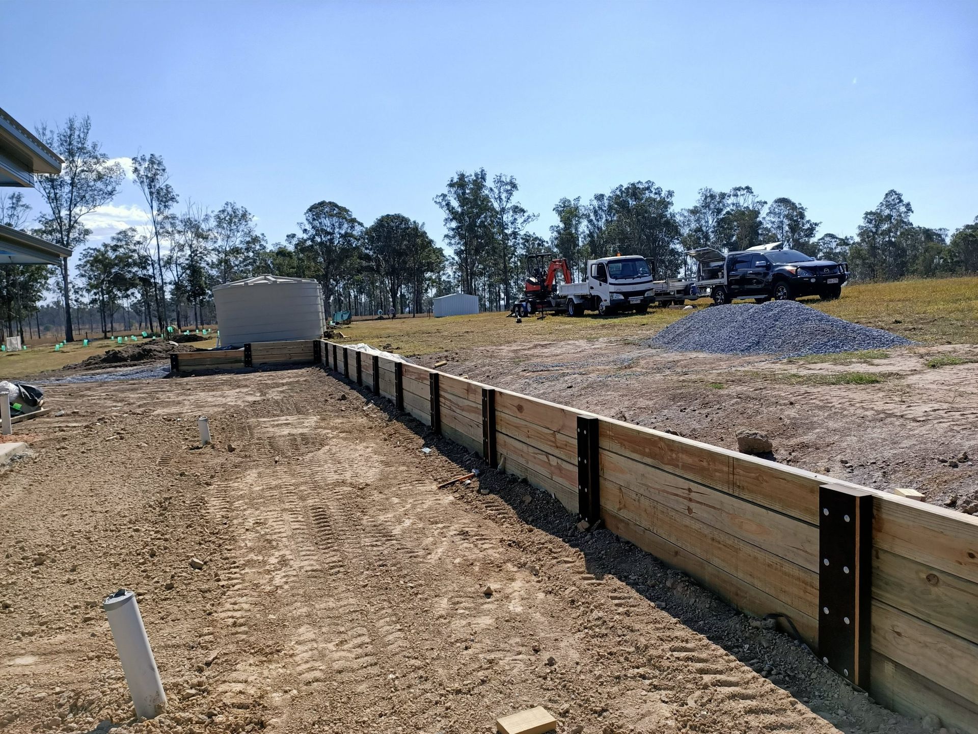 Wooden Retaining Wall Under Construction on a Dirt Lot — Quality Fences 4 U in Gympie, QLD