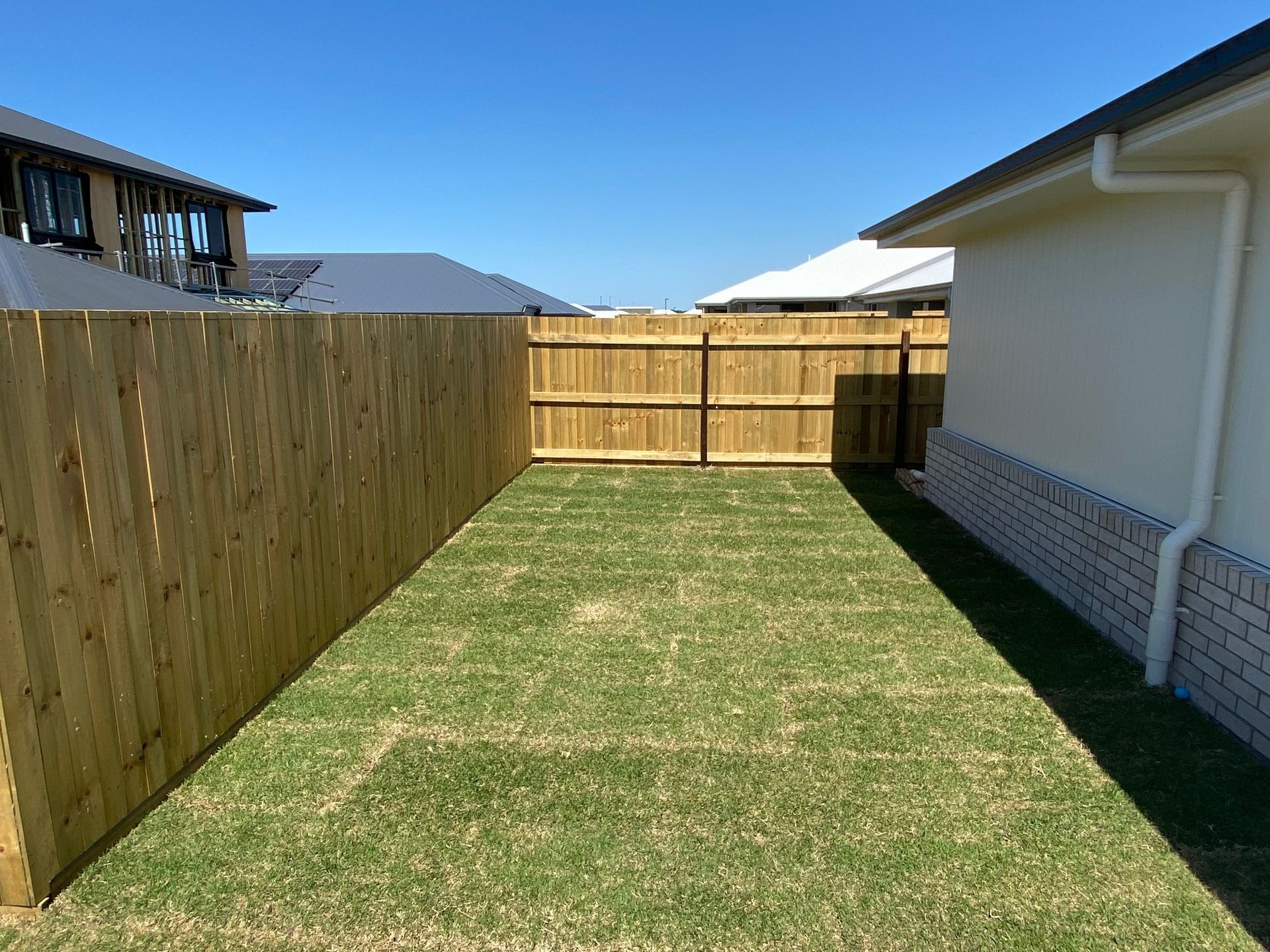 Fenced Backyard With a Green Lawn — Quality Fences 4 U in Tin Can Bay, QLD