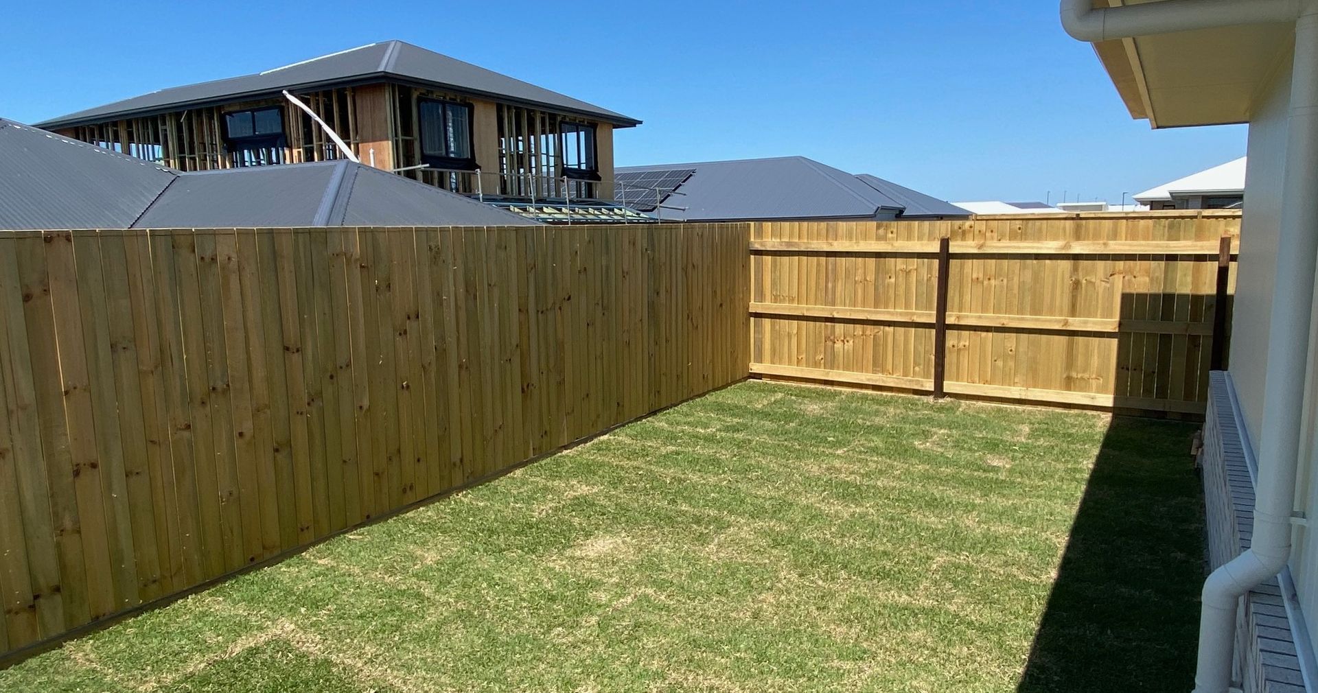 Grassy Backyard Enclosed by Wooden Fences — Quality Fences 4 U in Gympie, QLD