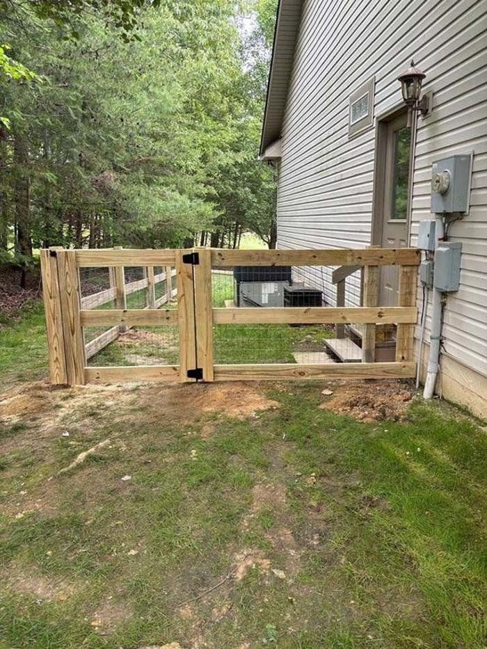 A wooden gate is sitting in front of a house.