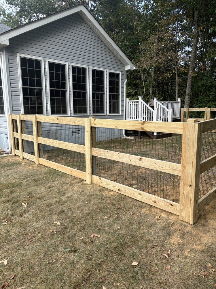 A wooden fence is sitting in front of a house.