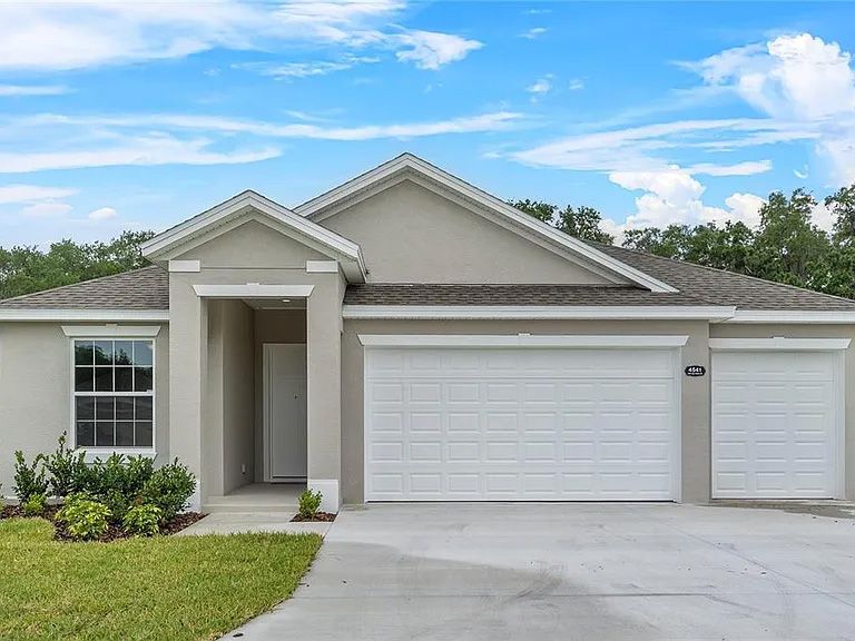 The front of a house with a white garage door