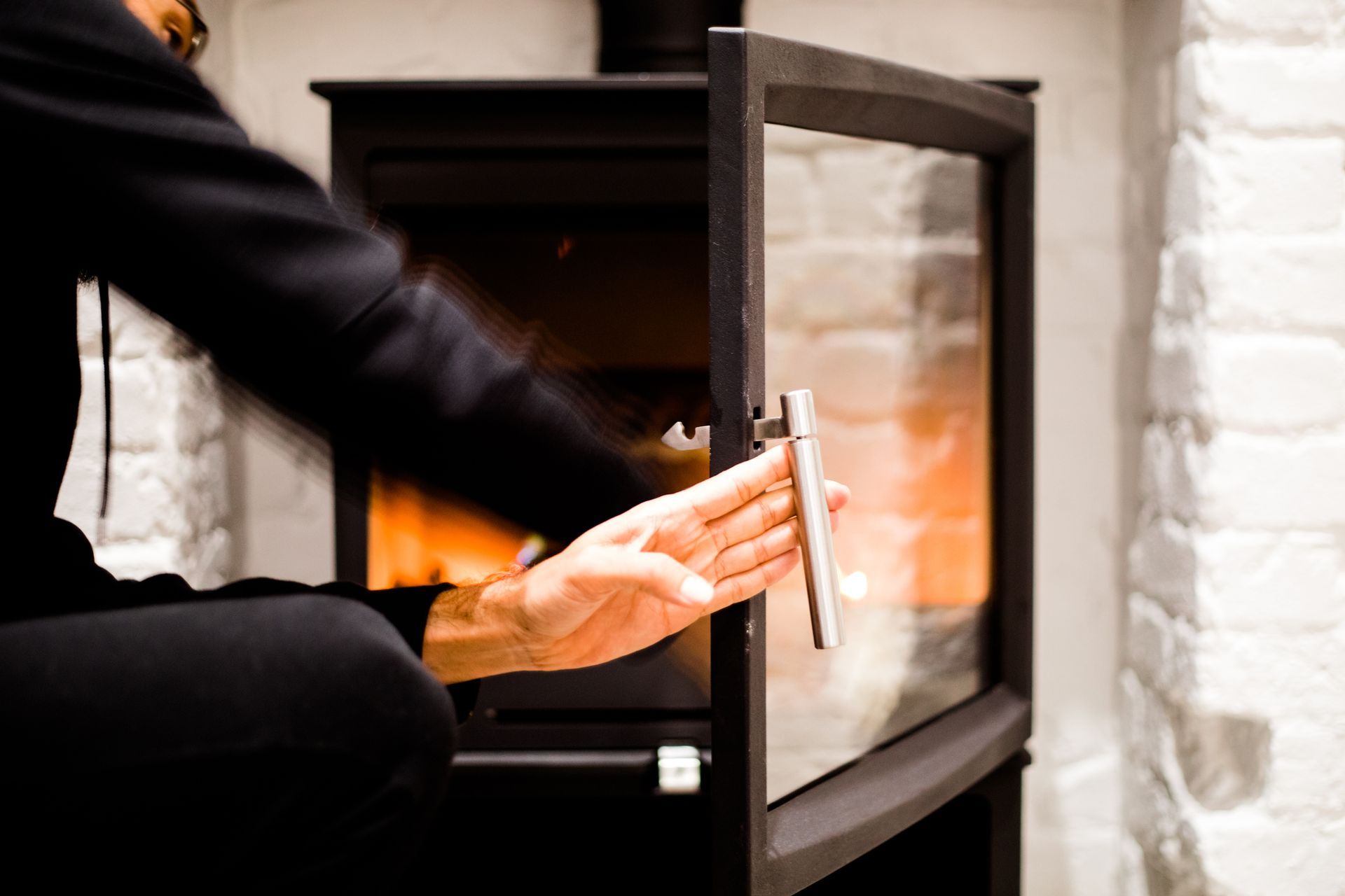 A man holding the door of the fireplace – Macungie, PA - Anytime Todd's Chimney Sweeping