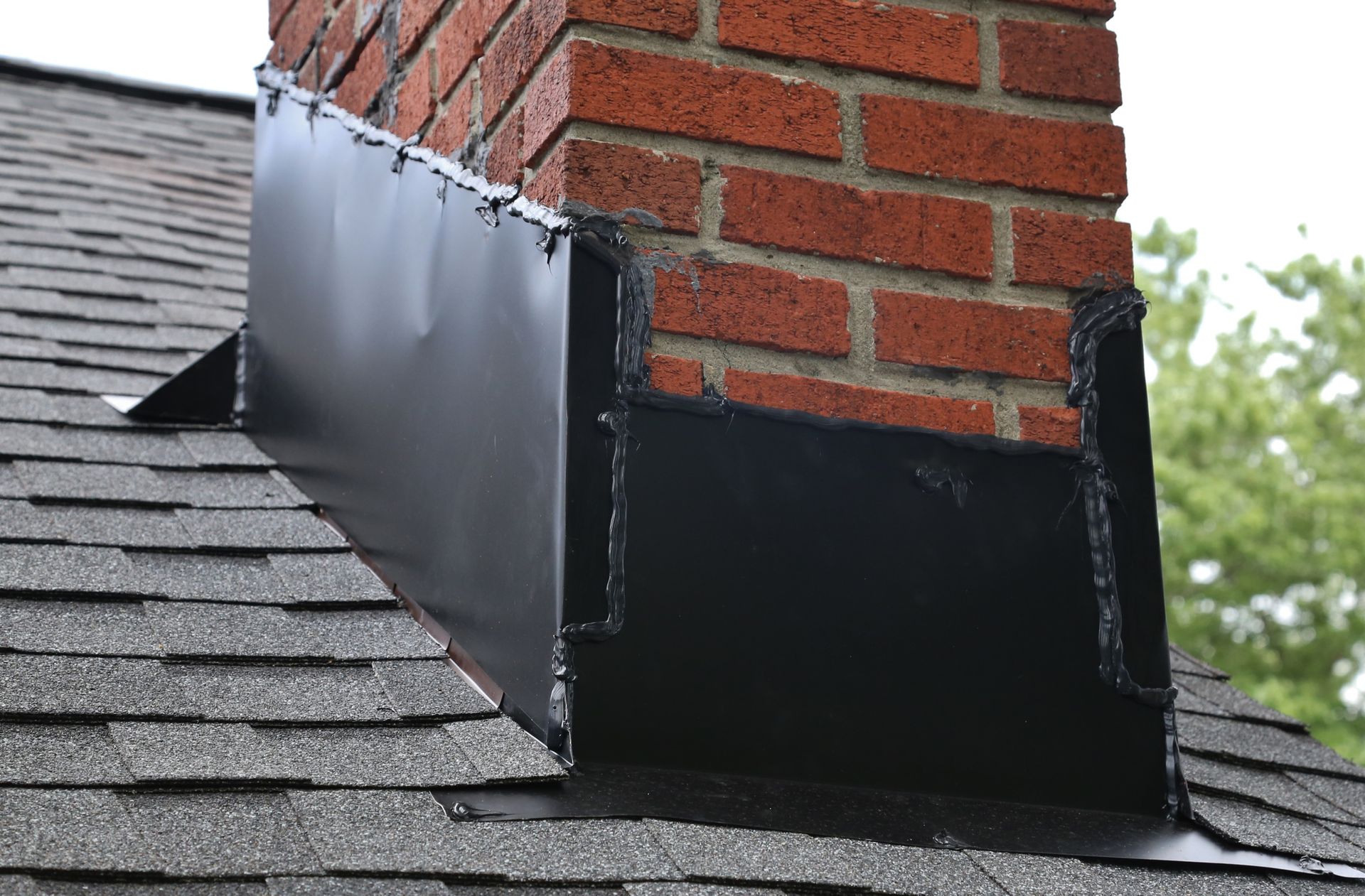 Metal flashing and caulk on a roof and brick chimney – Macungie, PA - Anytime Todd's Chimney Sweeping