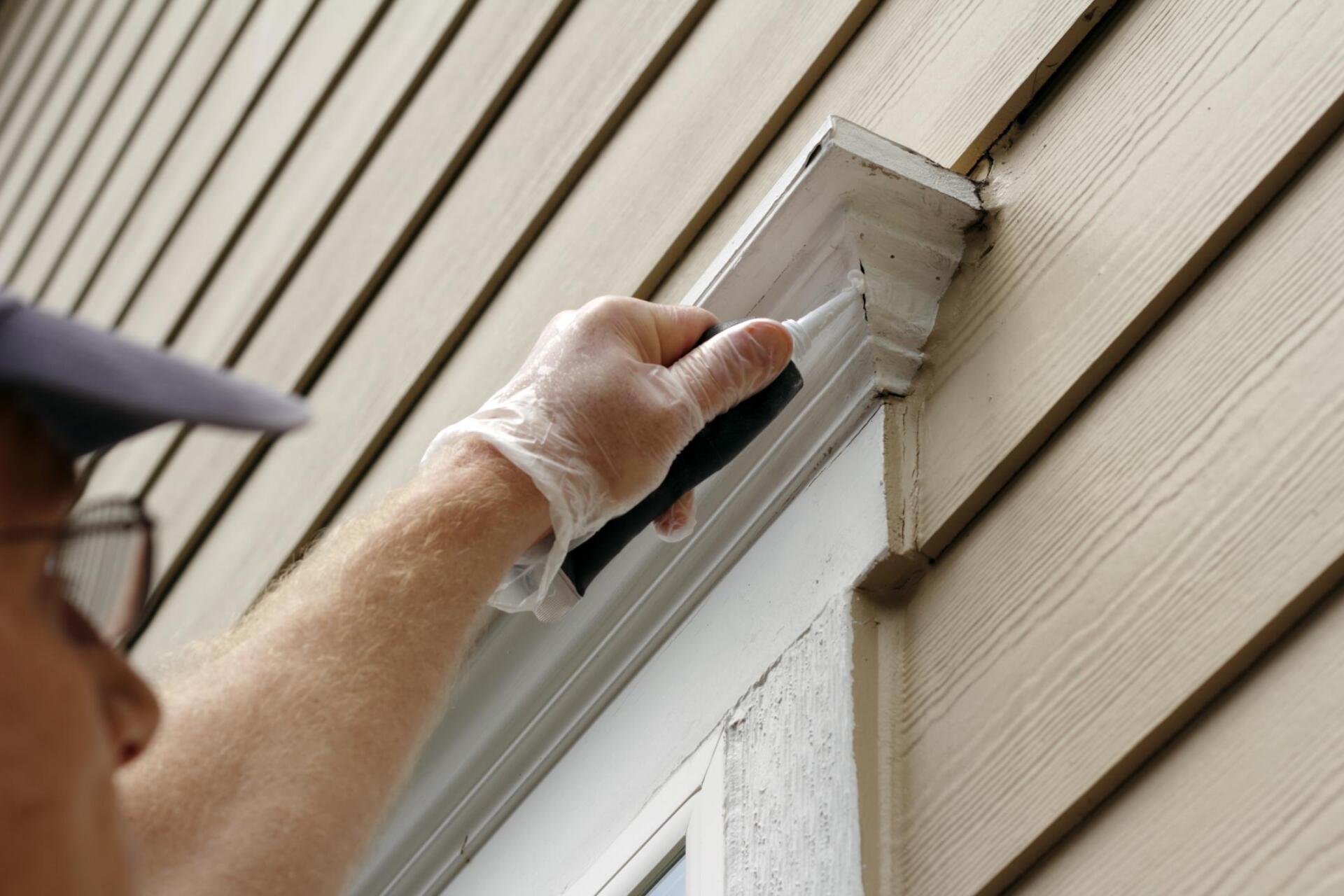 worker using a caulk